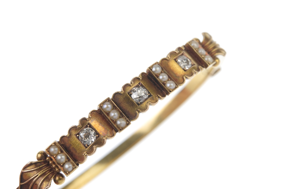 A late 19th century 15ct gold diamond and seed pearl hinged bangle. The front designed as three - Image 3 of 4
