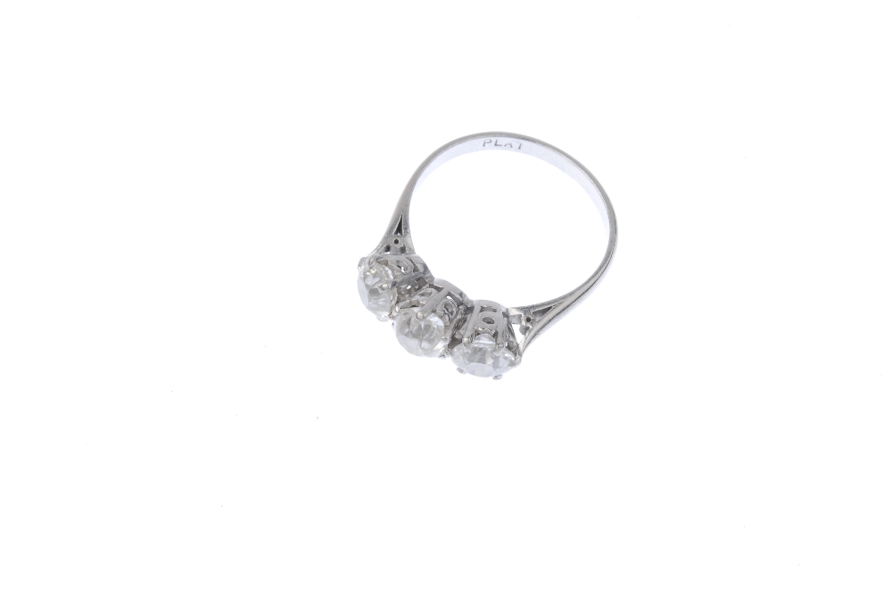 A diamond three-stone ring. The old-cut diamond line, to the plain band. Estimated total diamond - Image 2 of 3