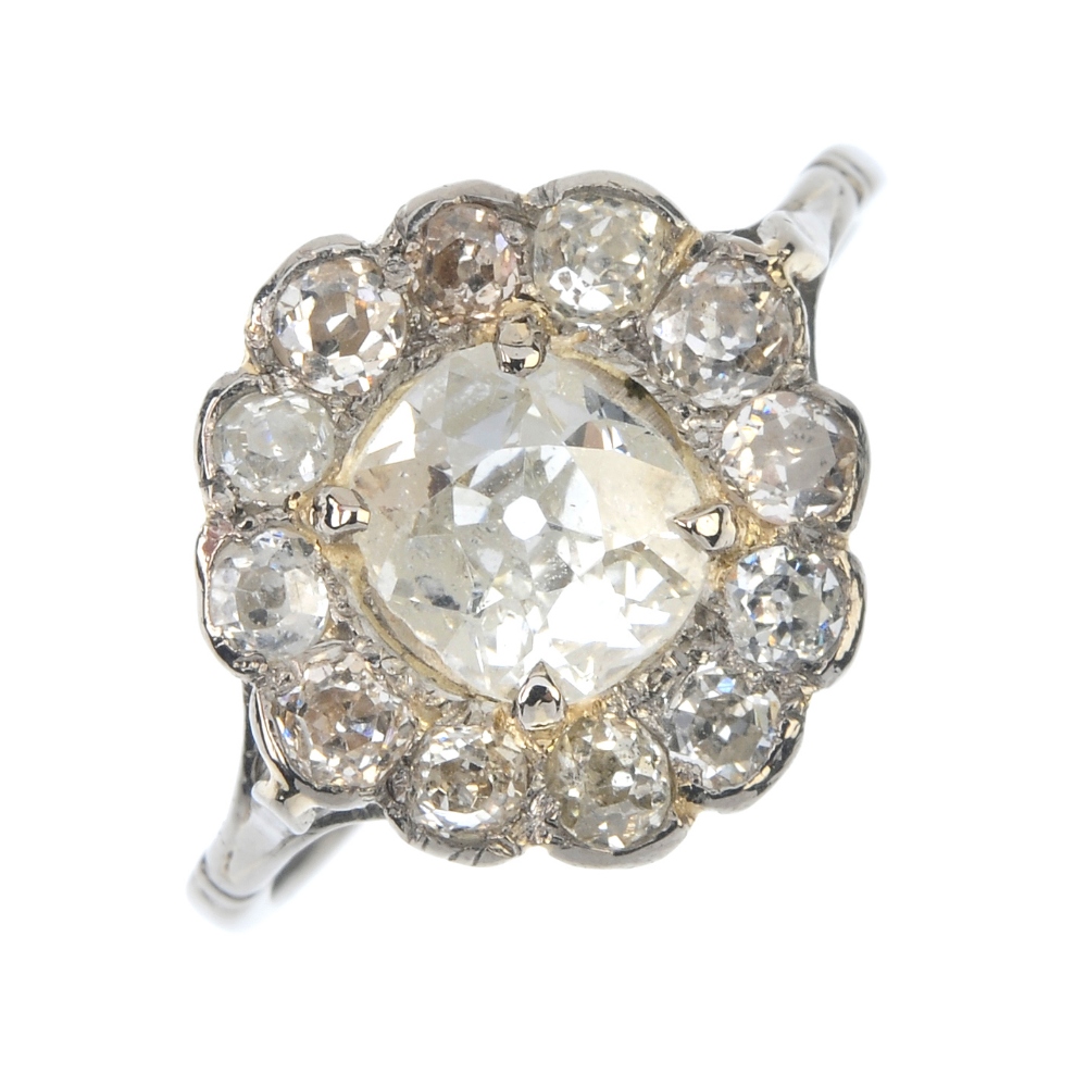 A mid 20th century diamond cluster ring. The old-cut diamond, within a similarly-cut diamond