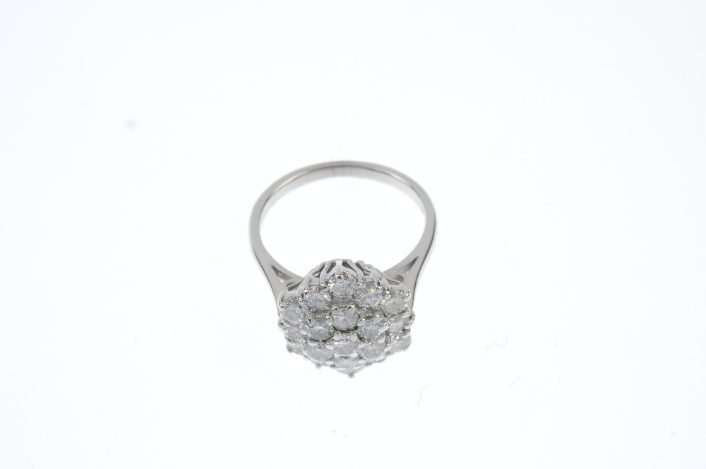 A diamond cluster ring. Designed as a brilliant-cut diamond stepped cluster, to the tapered band. - Image 2 of 3