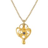 An Edwardian 15ct gold sapphire floral pendant. The textured flower with circular-shape sapphire