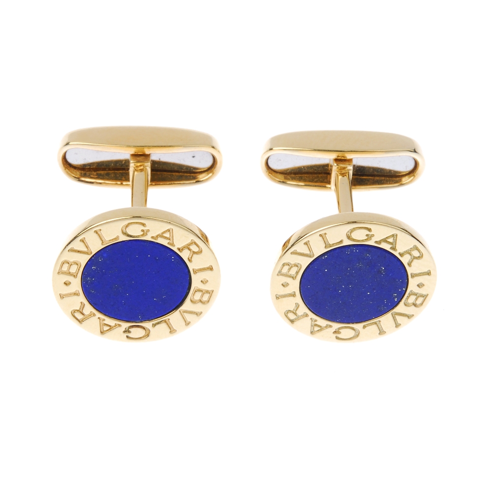 BULGARI - a pair of lapis lazuli cufflinks. Each designed as a lapis lazuli disc, within a Bulgari