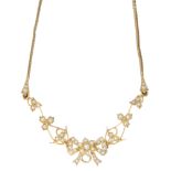 An early 20th century gold seed pearl floral necklace. Of openwork design, the seed and split