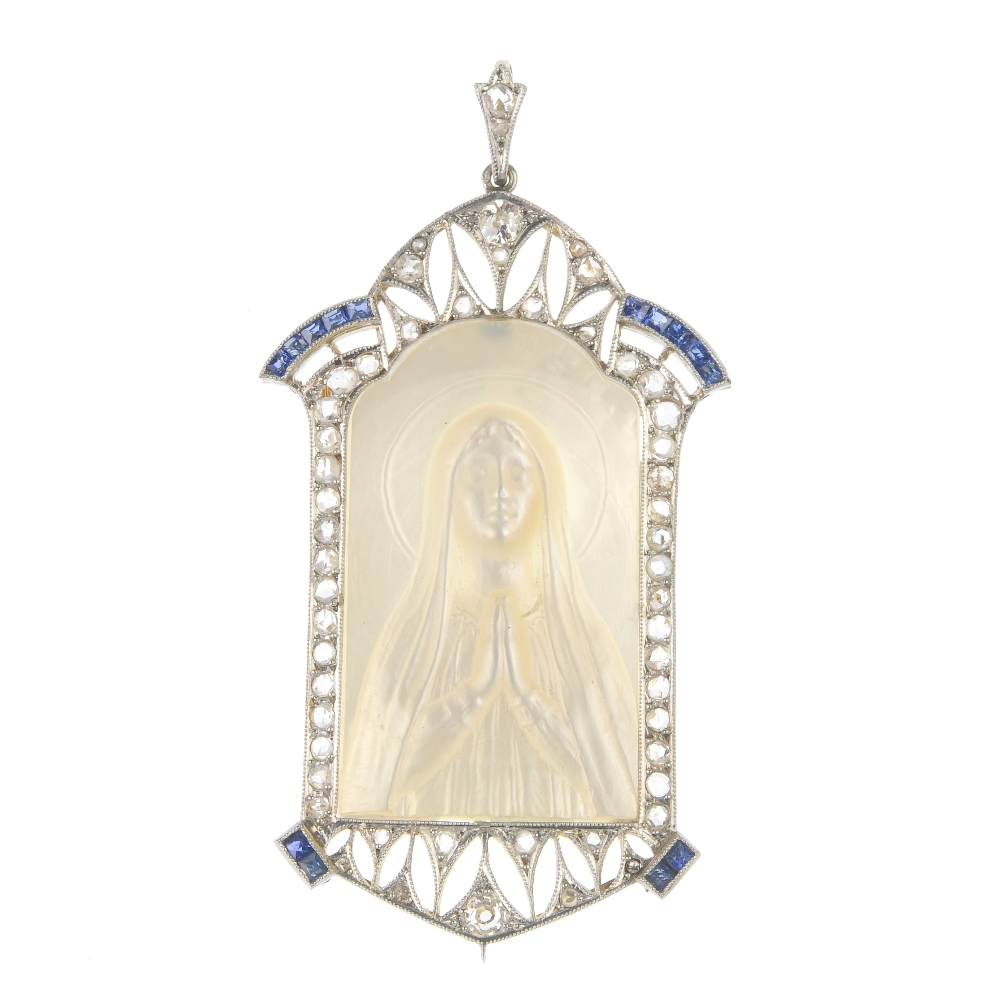A mother-of-pearl, synthetic sapphire and diamond pendant. The mother-of-pearl panel, carved to