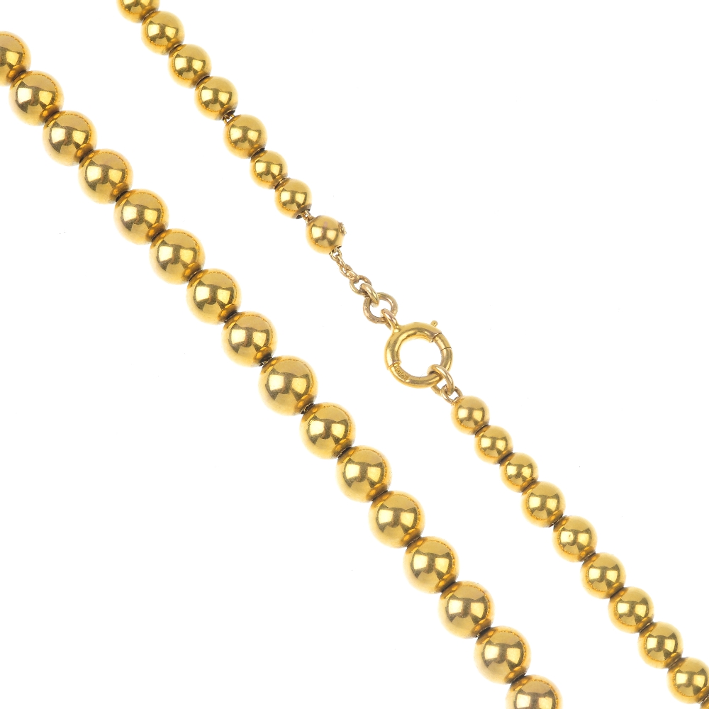 A late 19th century 9ct gold bead necklace and bracelet. The 9ct gold necklace designed as a