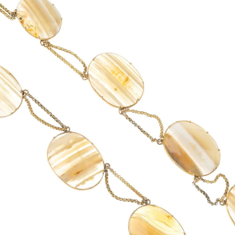 An early 19th century gold agate necklace. Designed as a series of banded agate panels, with fancy-