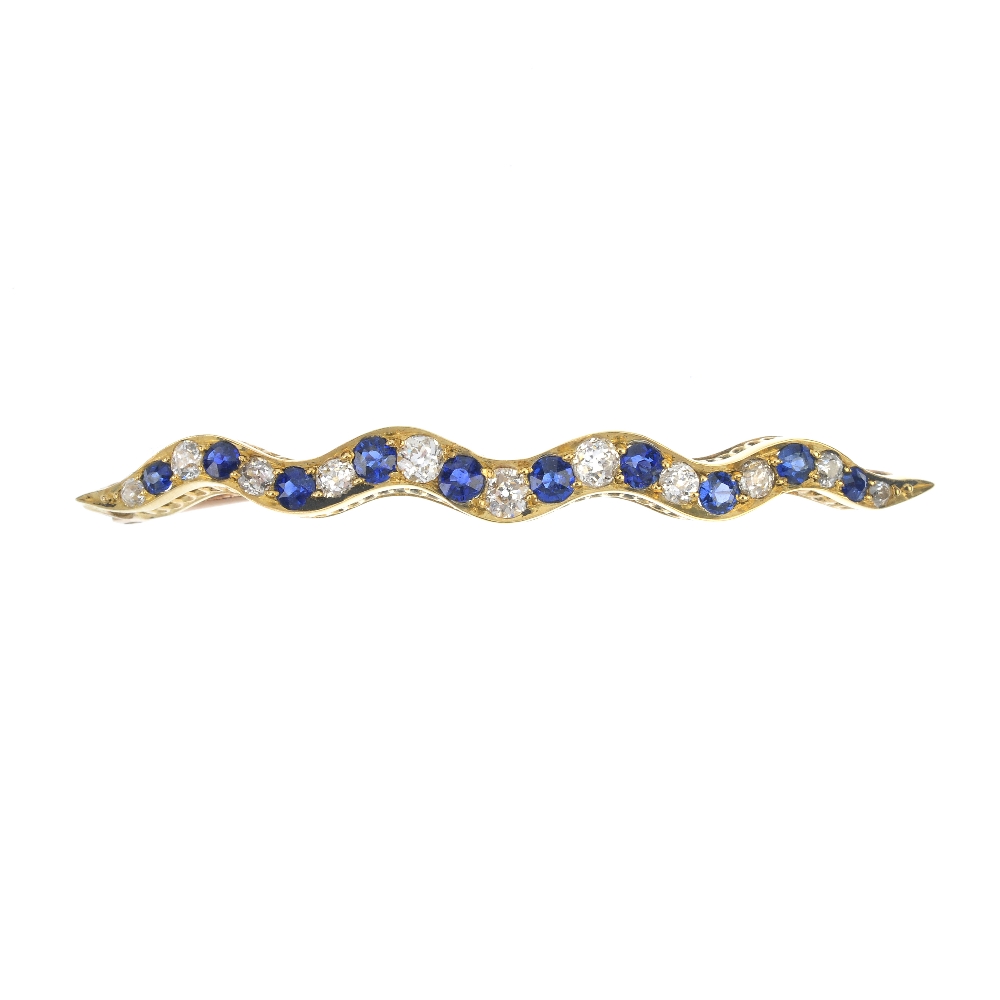A sapphire and diamond bar brooch. Designed as an alternating circular-shape sapphire and old-cut