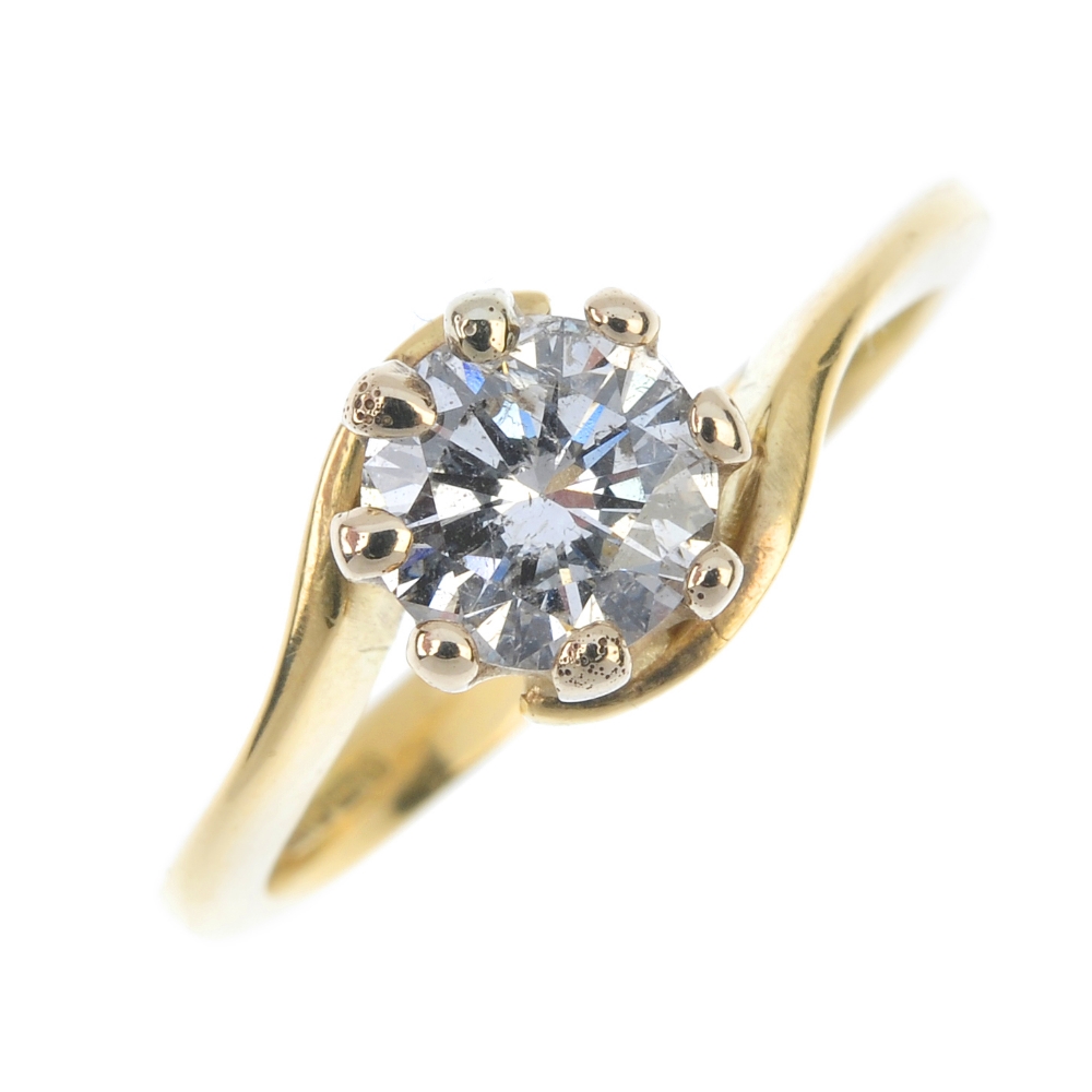 A diamond single-stone ring. The brilliant-cut diamond, to the crossover band. Estimated diamond