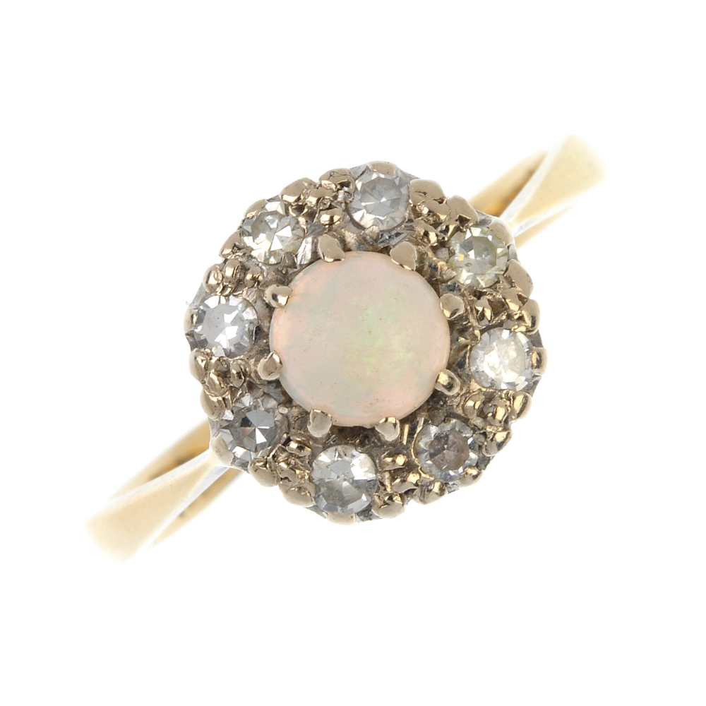 A mid 20th century 18ct gold opal and diamond cluster ring. The circular opal cabochon, within a