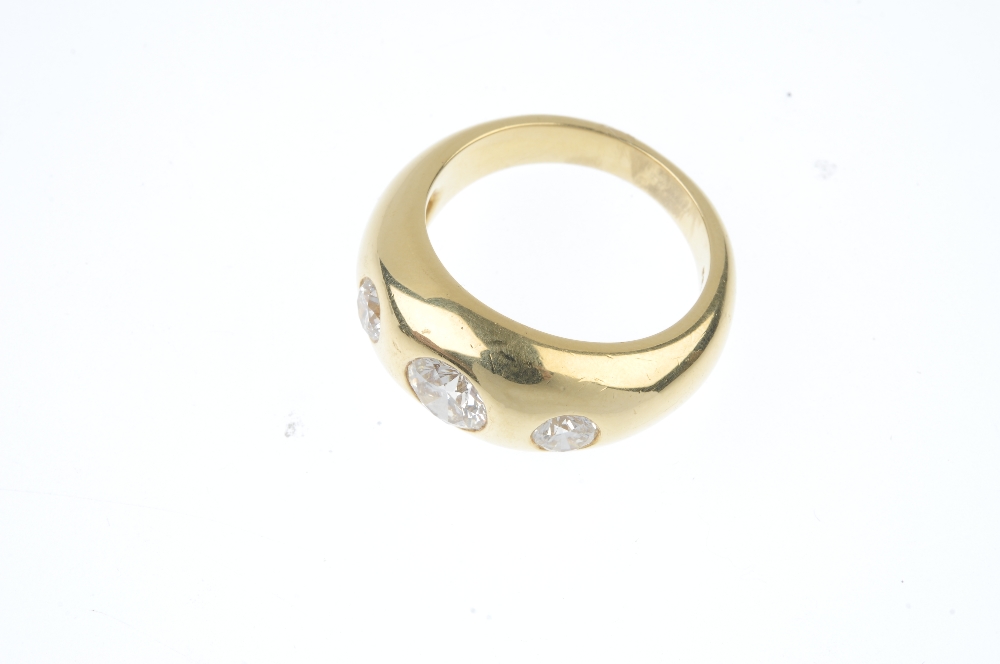 A gentleman's 18ct gold diamond three-stone ring. The brilliant-cut diamond graduated line, inset to - Image 2 of 4