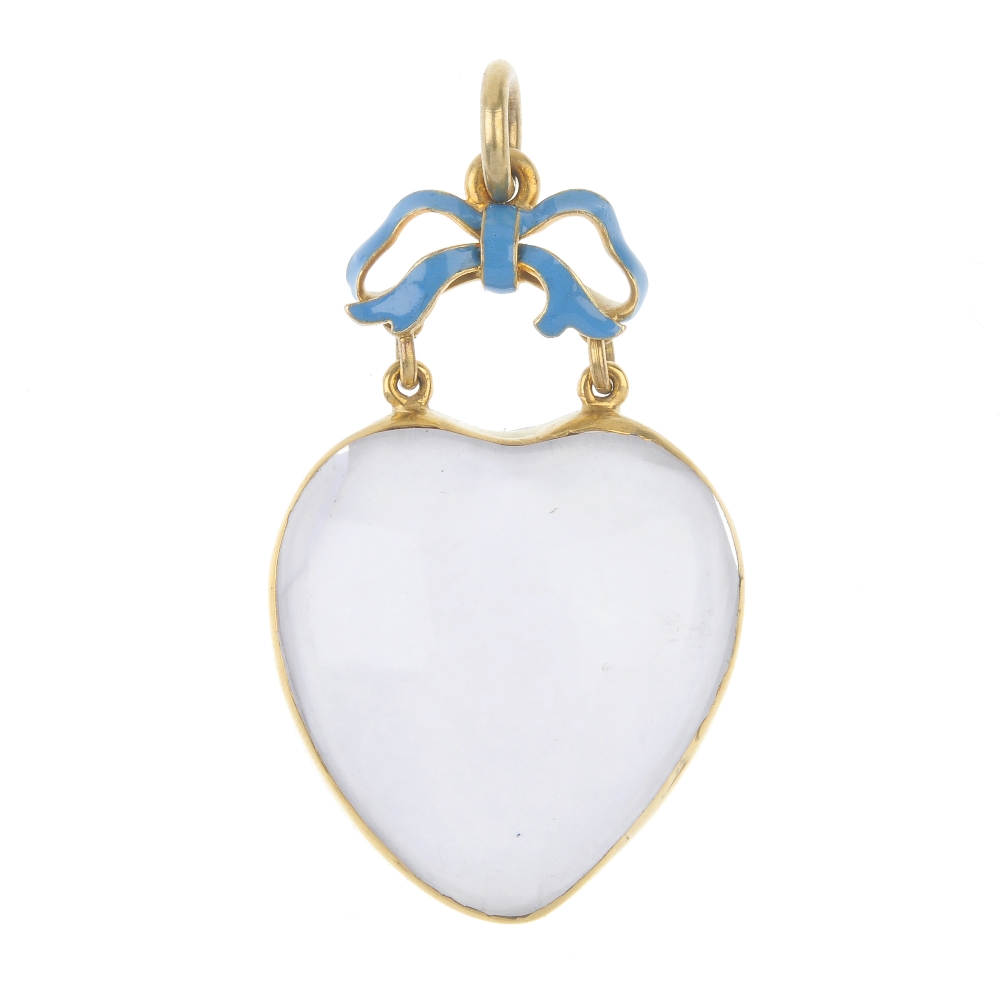 A late 19th century gold rock crystal enamel and quartz heart pendant. The heart-shape rock
