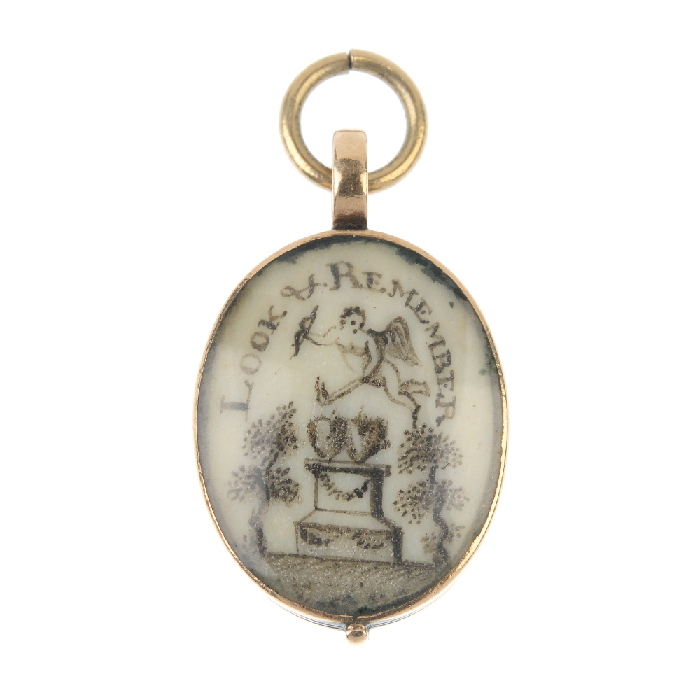 An early 19th century gold mourning pendant. Of oval outline, the painted ivory panel reading Look