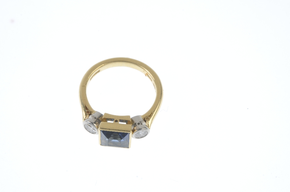 BOODLE & DUNTHORNE - an 18ct gold sapphire and diamond three-stone ring. The square-shape - Image 2 of 3