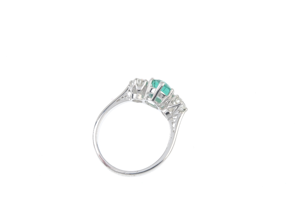 An emerald and diamond three-stone ring. The oval-shape emerald, with brilliant-cut diamond sides, - Image 3 of 3