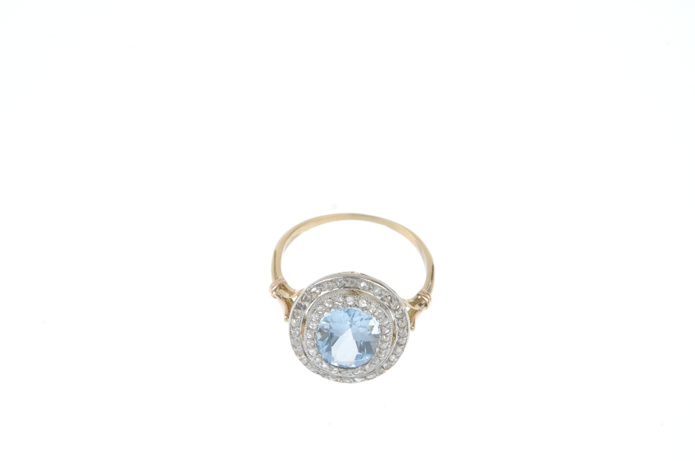 An early 20th century platinum and 18ct gold topaz and diamond cluster ring. The replacement oval- - Image 2 of 3