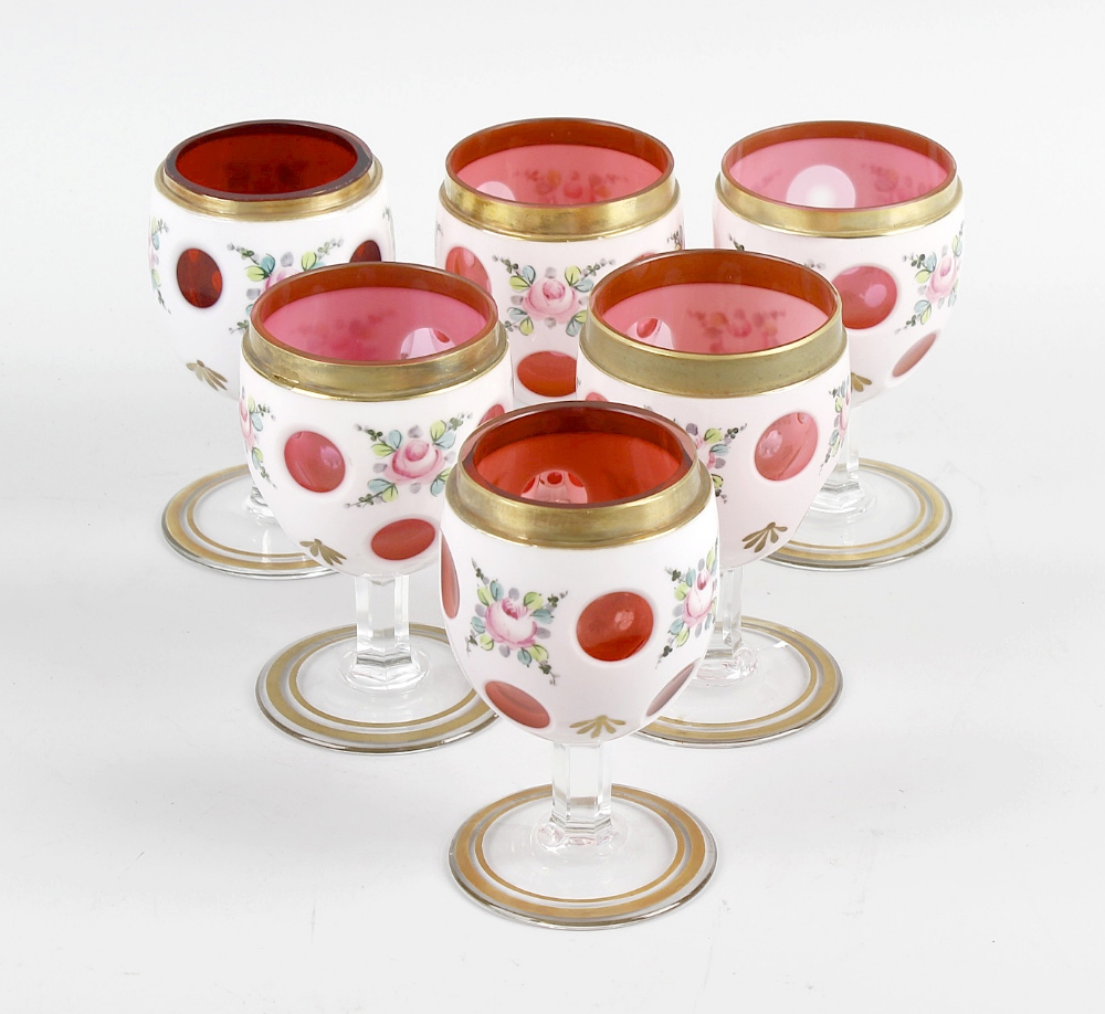 A matched set of six cranberry and white overlay drinking glasses, each with bucket bowl on prism