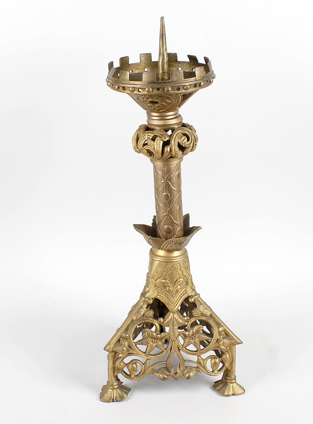 A cast metal pricket candlestick, the castellated top over acanthus collar and cylindrical stem