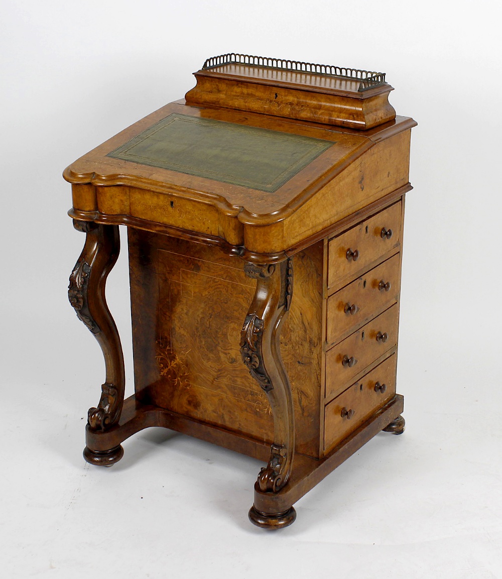 A mid Victorian inlaid walnut Davenport, the hinged superstructure with arcaded brass gallery,