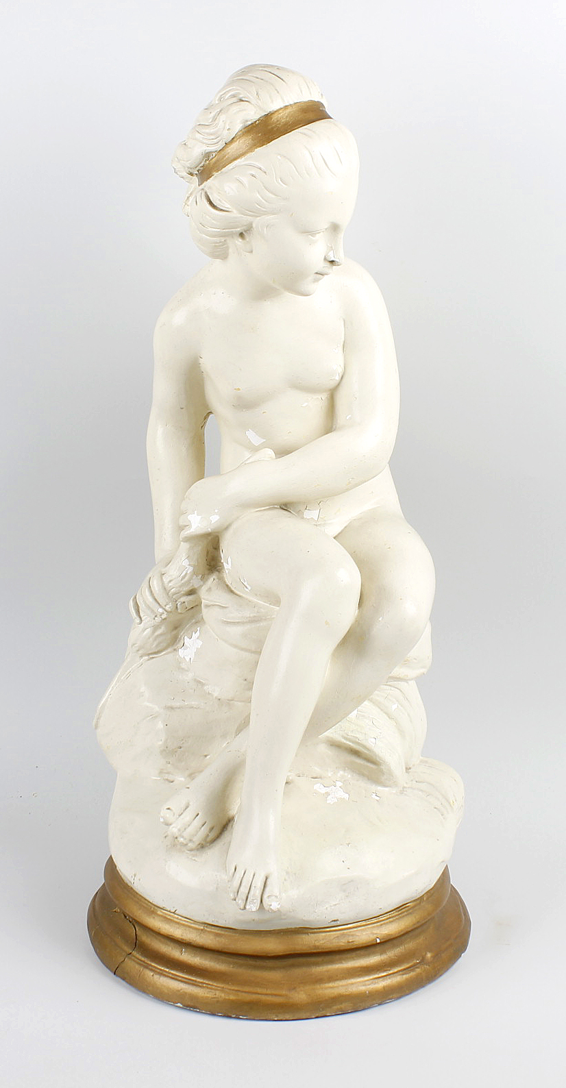 A Belgian plaster figure of a maiden. Early 20th century, modelled as a seated naked female