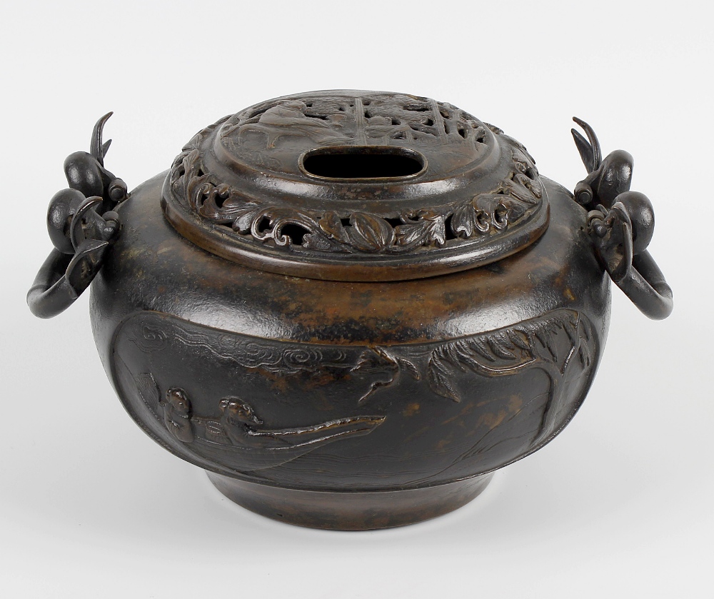 A large bronze incense burner and cover, the domed pierced lid depicting an elder seated among