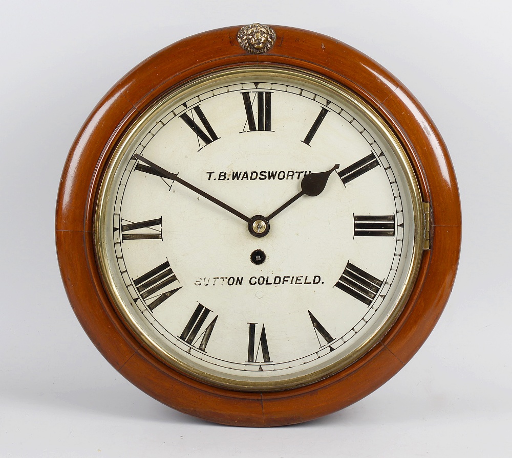 A late 19th century mahogany cased wall clock, the circular case with hinged opening glazed door,