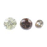 Three coloured diamonds, to include two brilliant-cut diamonds weighing 0.66 and 0.60ct, together