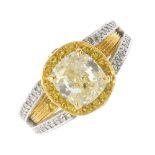 (112531) A diamond and colour treated diamond dress ring. The cushion-shape diamond, with