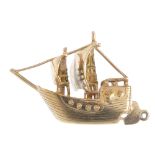 A ship charm. Designed as a two-masted ship with over-large rudder. Length 4.3cms. Weight 10.1gms.