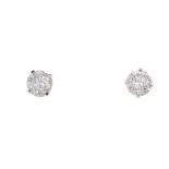 A pair of brilliant-cut diamond single-stone ear studs. Estimated total diamond weight 0.70ct, K-L
