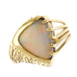 (87812) An opal dress ring. The triangular opal cabochon, with openwork and textured sides. Ring