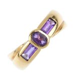 An 18ct gold amethyst dress ring. The oval-shape amethyst, with rectangular-shape sides and