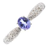 A 9ct gold tanzanite dress ring. The oval-shape tanzanite, with pave-set diamond sides and tapered