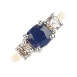 An 18ct gold sapphire and diamond three-stone ring. The cushion-shape sapphire, with brilliant-cut