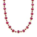 A glass-filled ruby and diamond necklace. Designed as a series of oval-shape glass-filled rubies,