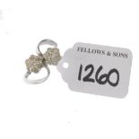 (PWN692) An 18ct gold diamond floral cluster crossover ring. Estimated total diamond weight 1ct.
