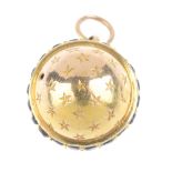 A late Victorian gold garnet stanhope charm. The star-engraved sphere, encircled by a circular-shape