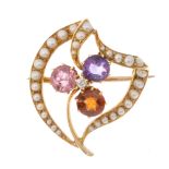 An early 20th century gold diamond, sapphire, amethyst and garnet brooch. The circular-shape pink