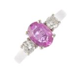(112531) A sapphire and diamond three-stone ring. The oval-shape pink sapphire, with brilliant-cut