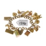 (PWN957) A 9ct gold charm bracelet suspending eighteen assorted charms. Hallmarks. Weight 61.1gms.