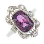 A mid 20th century 18ct gold spinel and diamond ring. Of openwork design, the cushion-shape purple