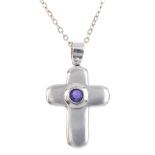 An amethyst cross pendant. The circular amethyst collet, atop a textured cross, suspended from a