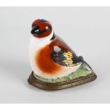 An enamelled box, modelled as a seated bird having further printed scene of birds to the hinged