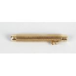 A Sampson Mordan & Co 9ct gold retractable pen, having engine turned decoration to body, central
