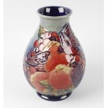 A Moorcroft pottery Finches pattern vase, of pear form with a merging blue glaze ground, impressed