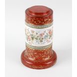 A 19th century cranberry glass pedestal, of cylindrical form leading a spreading base, with wide