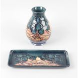 A small modern Moorcroft pottery vase, of pear form with continuous waterscape on a split green,