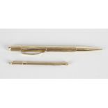 A 9ct gold mechanical pencil, the body having engine turned decoration and vacant cartouche, 4.75 (