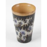 A Doulton Lambeth beaker, of tapering form having incised scrolling foliage with raised blue