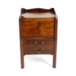 A George III mahogany night cupboard, having a lobed tray top above twin cupboard doors and an