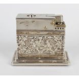 A Dutch silver mounted table lighter, of rectangular form having embossed tavern scenes and raised